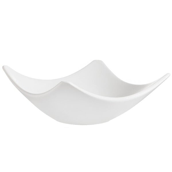 A CAC bone white porcelain bowl with a curved edge on a white background.