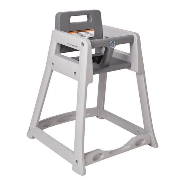 A gray Koala Kare high chair with a tray on a table.