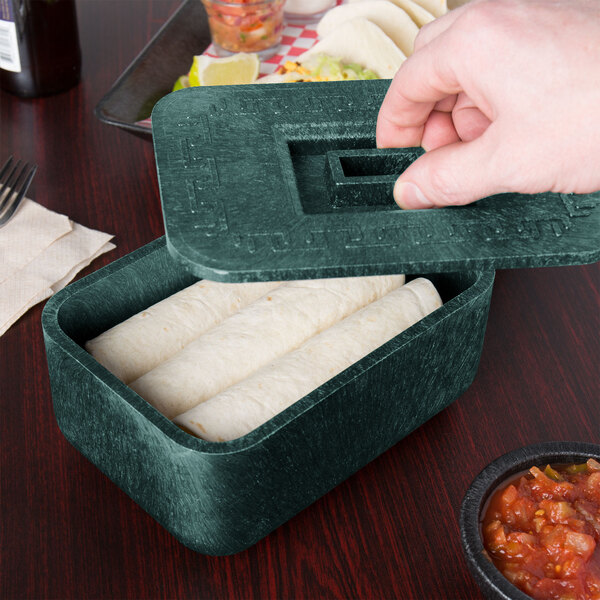 A person holding a HS Inc. green multi-purpose container with food in it.