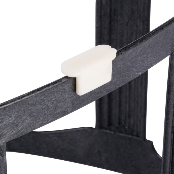 A black plastic HS Inc. Tower of Pizza stand on a black surface.