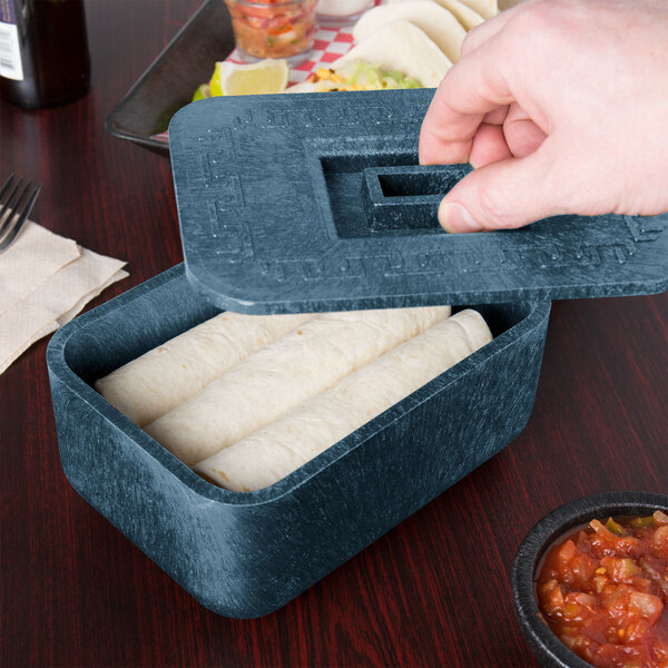 A person holding a blue HS Inc. multi-purpose container with food in it.