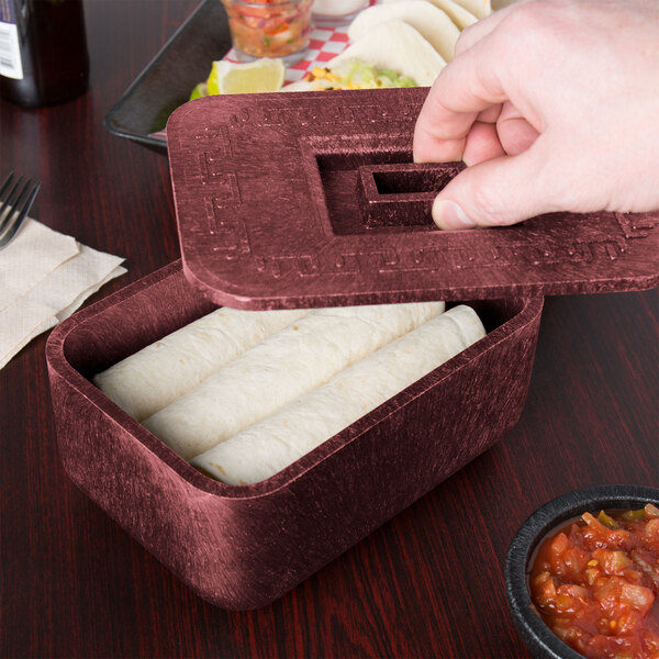 A person holding a red HS Inc. multi-purpose container with food inside.