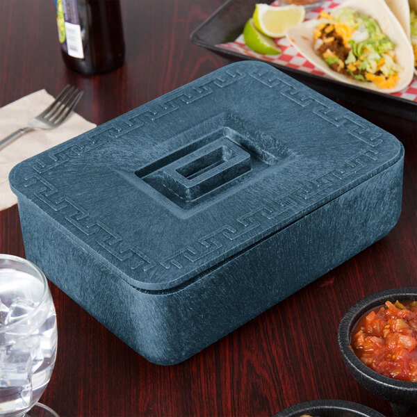 A blue HS Inc. multi-purpose container with a lid on a table.
