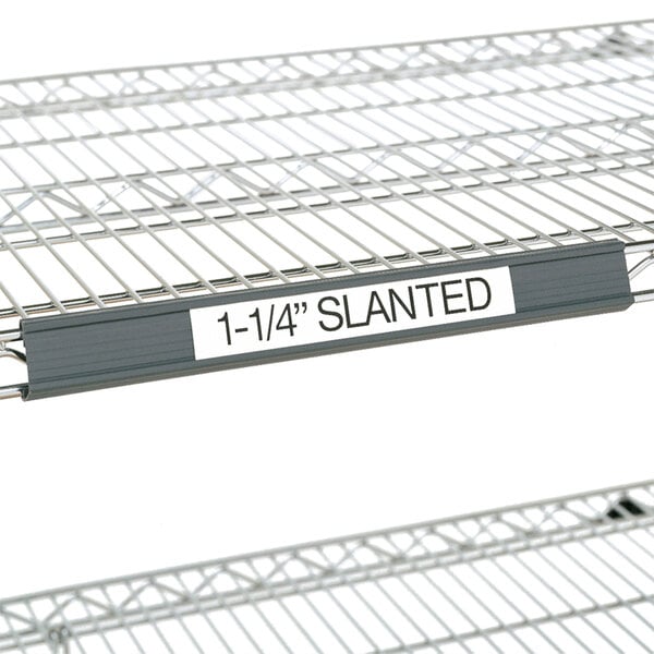 A gray Metro slanted plastic label holder on a shelf.