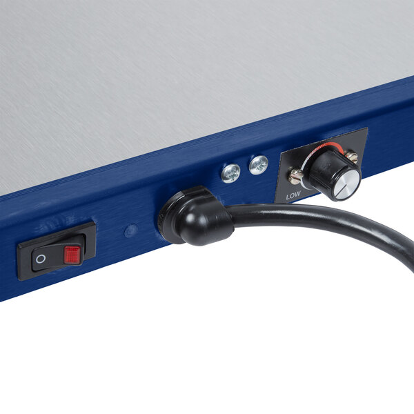 A blue and silver Hatco Glo-Ray heated shelf on a table.