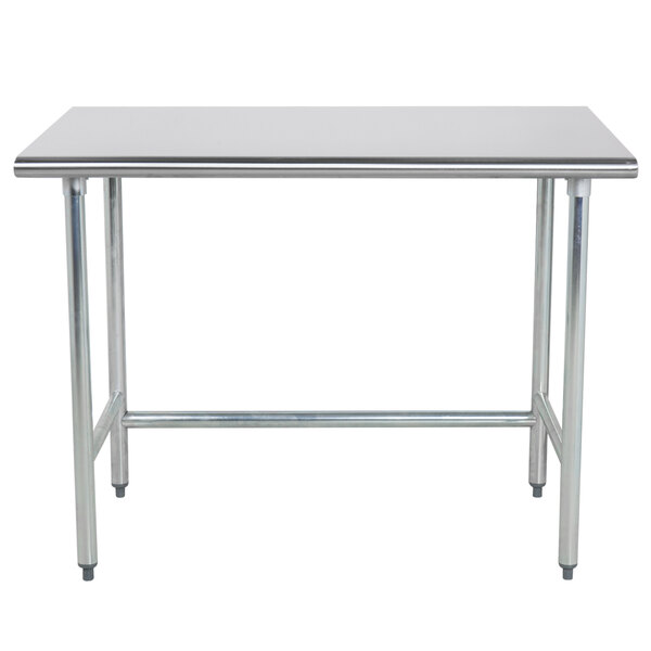 A stainless steel Advance Tabco work table with metal legs.