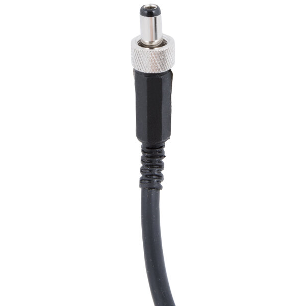 A close up of a black cable with a white plastic plug.