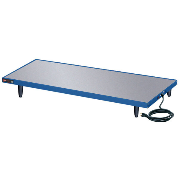 A blue Hatco Glo-Ray heated shelf on a white table with a cord.