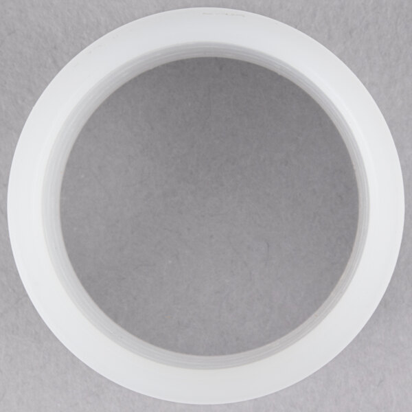 A white plastic bushing with a clear center.