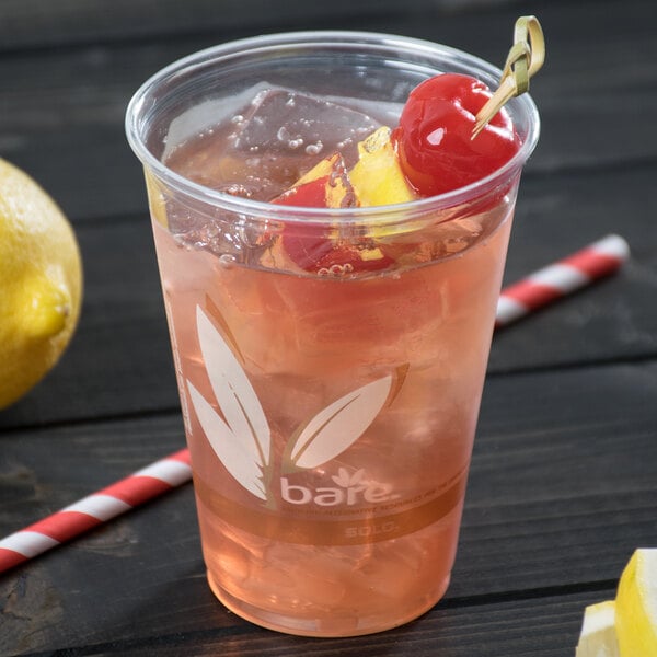 A clear Bare by Solo disposable plastic cup with a pink drink, a cherry, and a straw.