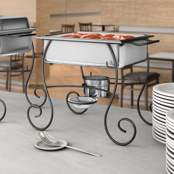 A table set with a Choice half size chafer with food on it.