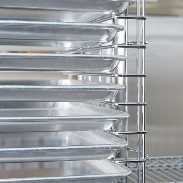 A Metro chrome tray slide holding metal trays.