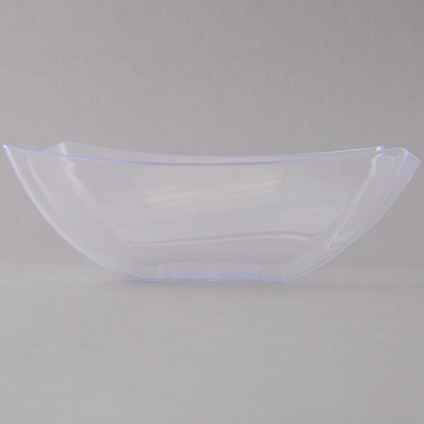 A clear plastic bowl with a blue edge on a white surface.