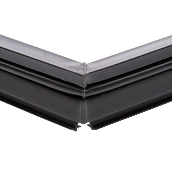 The black plastic corner of a True 810778 equivalent magnetic bottom door gasket.