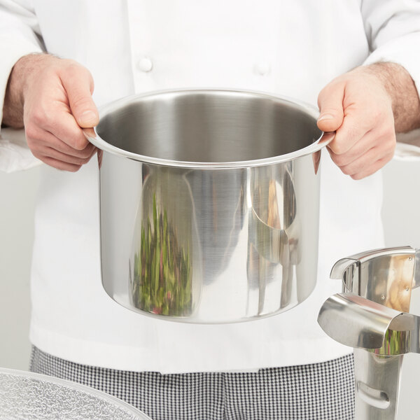 A person holding a silver pot.