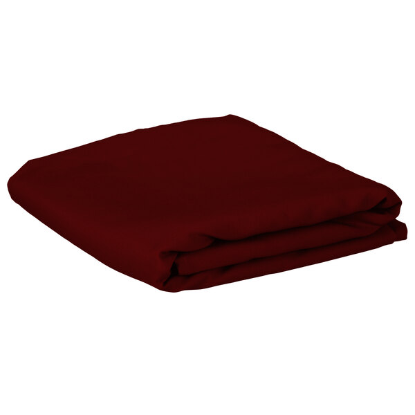 A folded burgundy rectangular Intedge table cover.