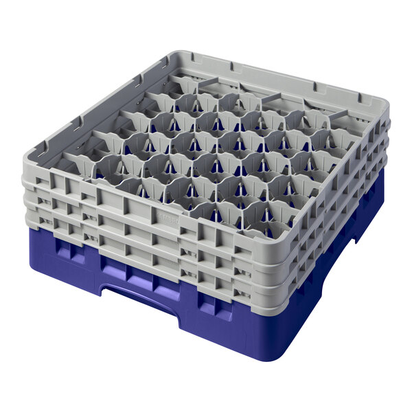 A navy blue plastic Cambro glass rack with many compartments.