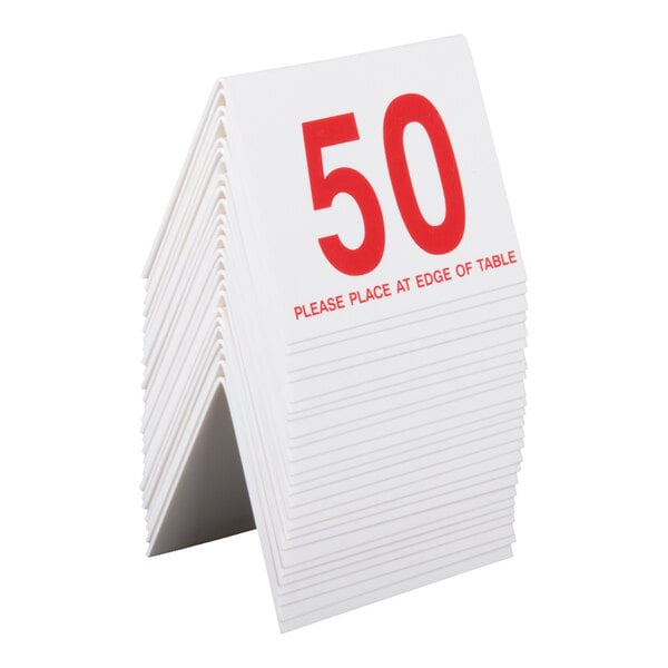 A stack of white, tent-shaped table cards with large red numbers and text, showing the number 50 on the front card.