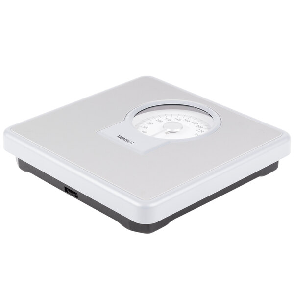 A white Conair Thinner dial scale on a white surface.