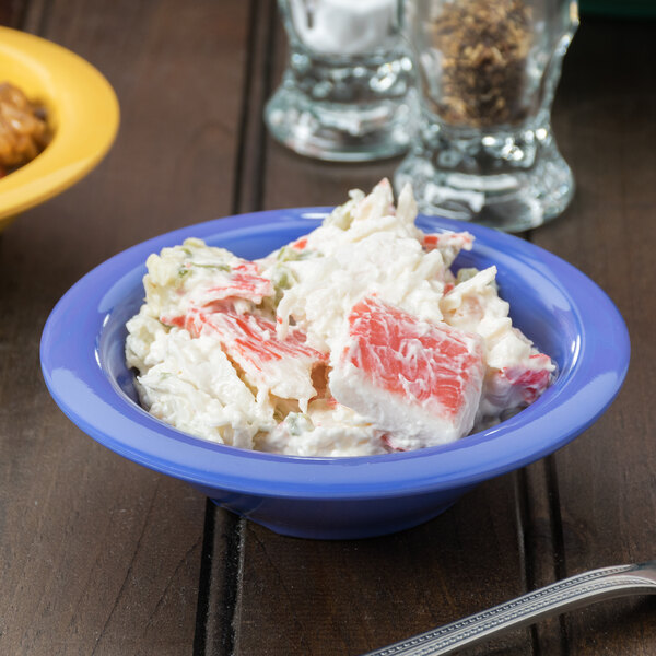 A peacock blue melamine bowl filled with crab salad.
