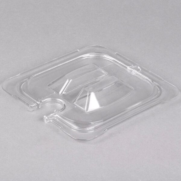 A clear Carlisle StorPlus plastic lid for a 1/6 size food pan with a spoon notch.