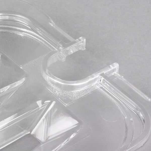 A Carlisle clear plastic lid with a handle and spoon notch.