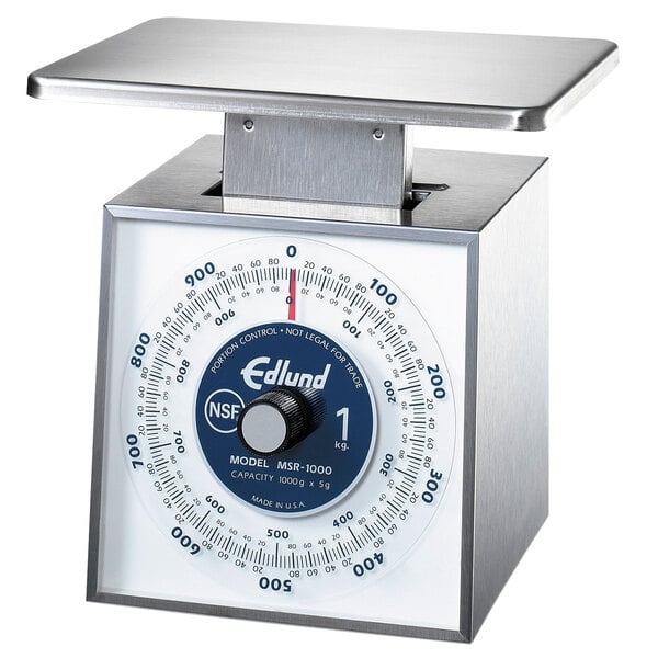 An Edlund stainless steel portion scale with a white dial on a counter.