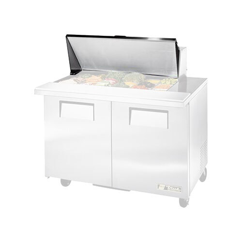 A True 870340 lid on a commercial refrigerator with food on top.