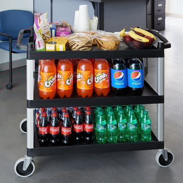A black Cambro utility cart with three shelves holding food and drinks.
