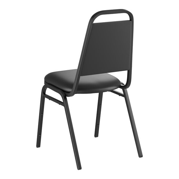 A black stackable banquet chair with a 1-inch padded seat and metal frame.