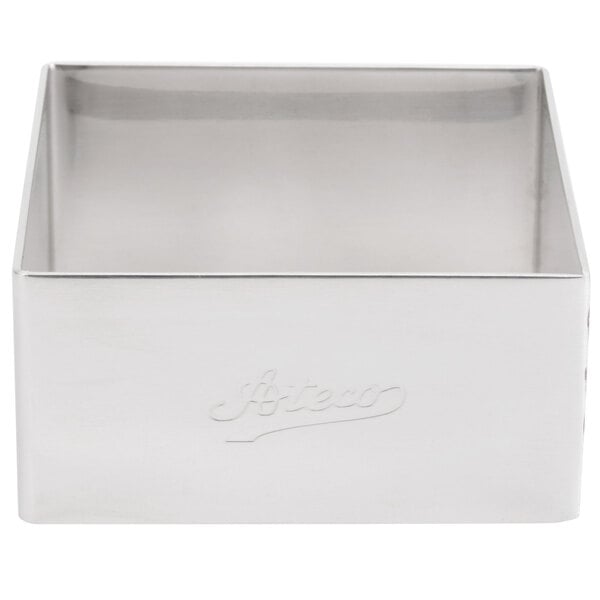 A stainless steel square mold with a logo on the lid.