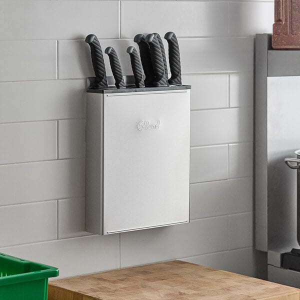An Edlund stainless steel knife rack holding knives.