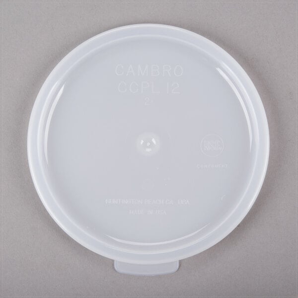 A white plastic lid for a Cambro clear crock with white text.