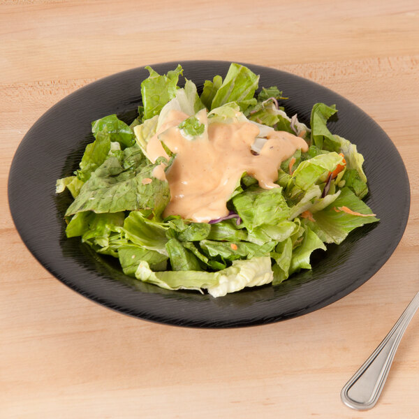 A salad in a black GET Etchedware bowl.