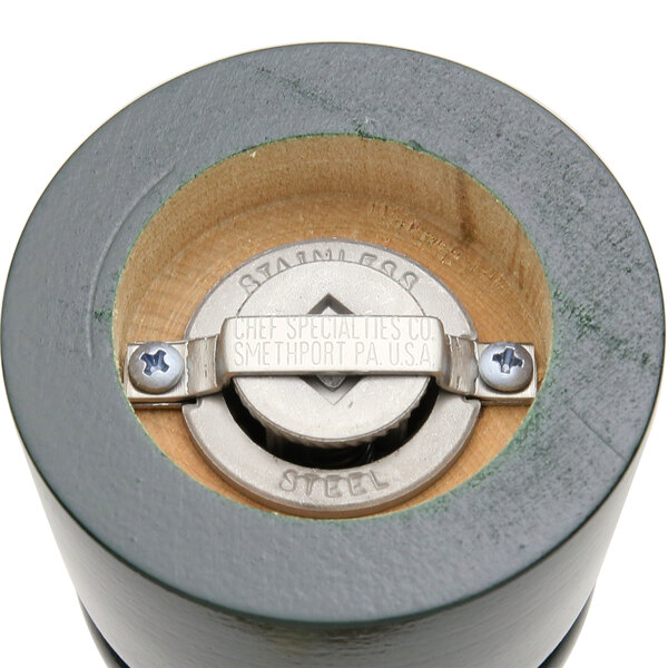 A close-up of a Chef Specialties Forest Green pepper mill on a table.