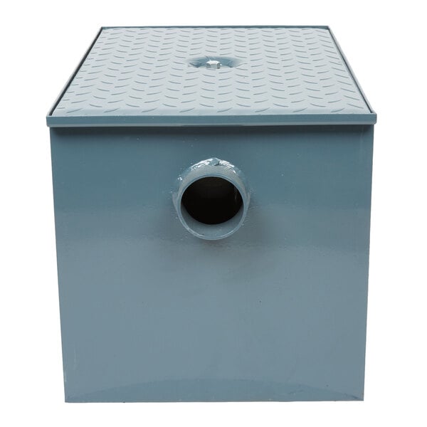 A blue rectangular Watts grease trap with a hole in the bottom.