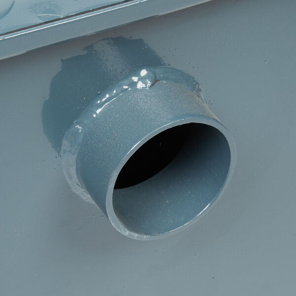 A close-up of a Watts WD-25 grease trap pipe.