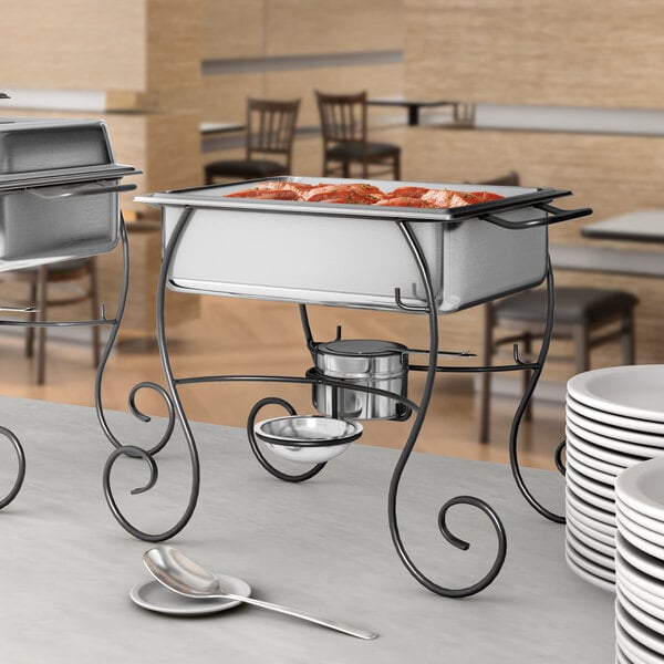 A Choice half size chafer on a table with white plates and a spoon on a stand.