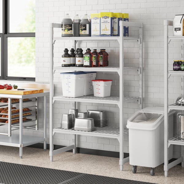 A Cambro Premium Camshelving unit with vented shelves holding containers.