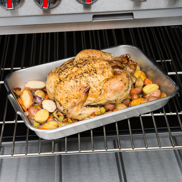 Roasted chicken and potatoes in a stainless steel pan