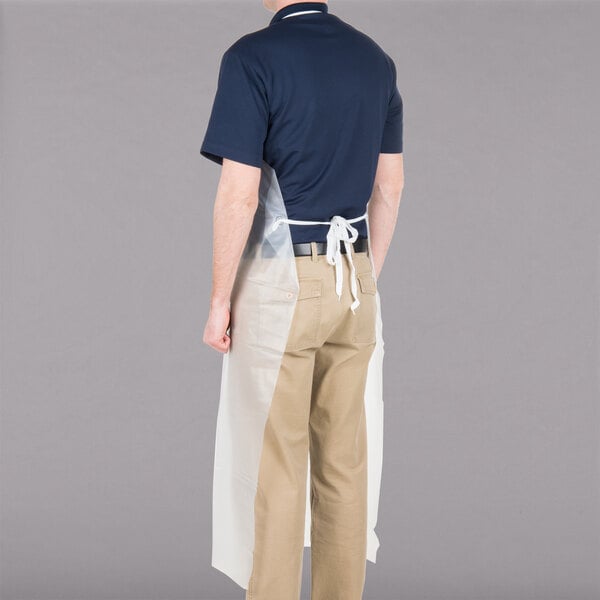 A man wearing a San Jamar clear plastic dishwasher apron.