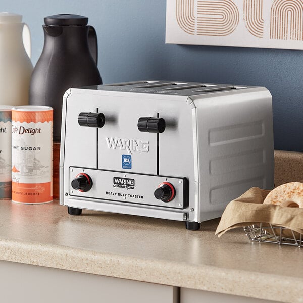 A silver Waring commercial toaster on a counter.