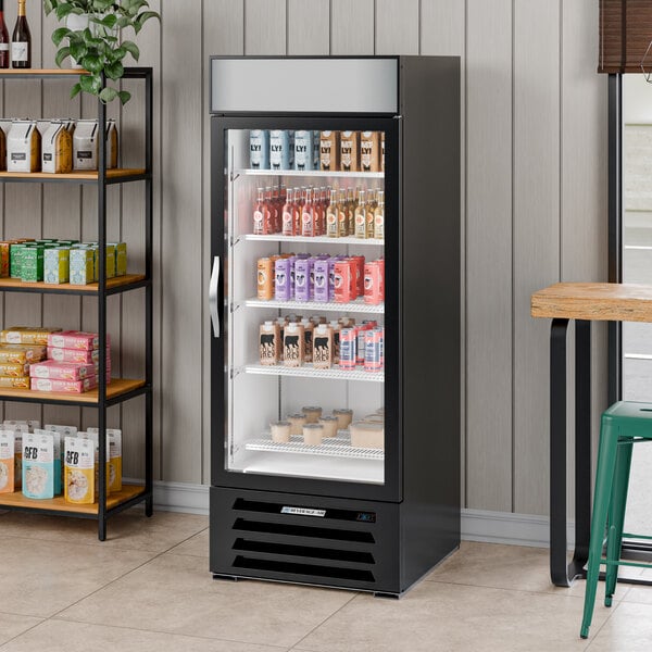 A black glass door merchandiser refrigerator with a white interior, stocked with various beverages and food items.