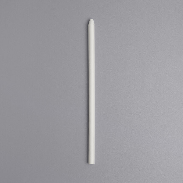 a white pencil on a gray surface