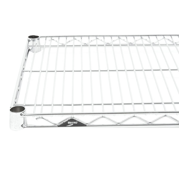 A Metro Super Erecta stainless steel wire shelf with a metal base and two holes.