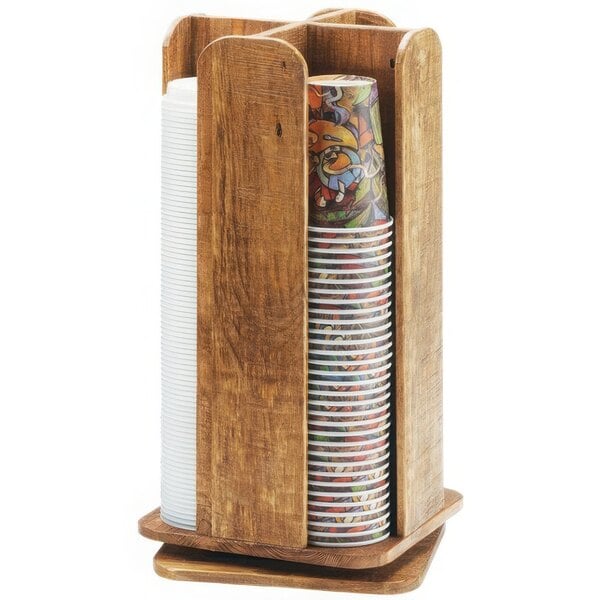 A Cal-Mil Madera wooden cup and lid organizer with a stack of paper cups.