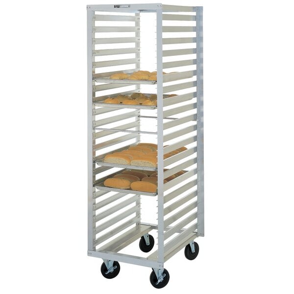 A Metro sheet pan rack with trays of bread on it.