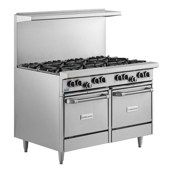 A large stainless steel Garland range with 8 burners and 2 ovens.