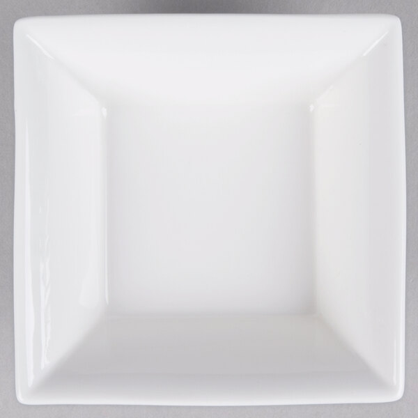 A white square bowl with a black border on a gray surface.
