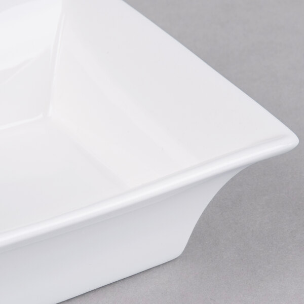 An Arcoroc white square flared bowl.